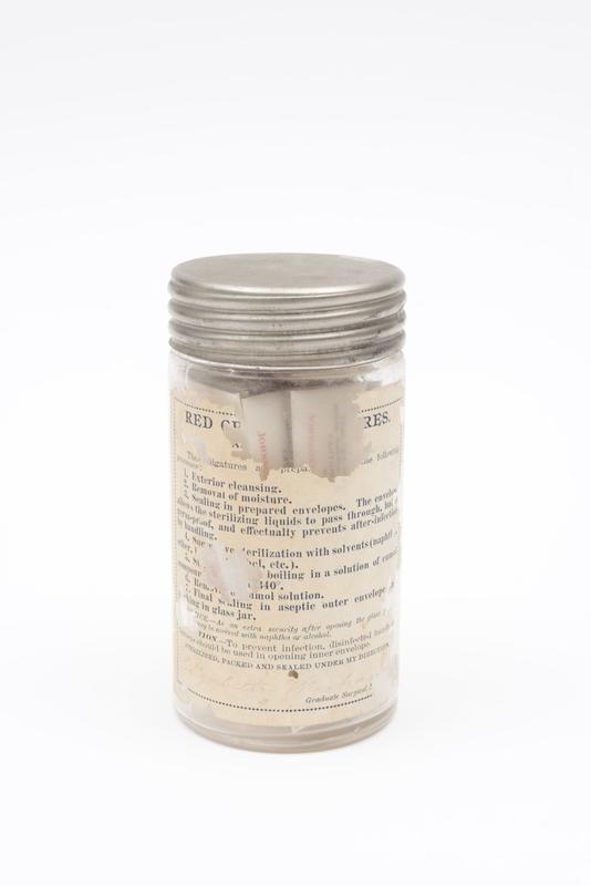 Silk ligatures, inside lidded jar labelled 'Red Cross Aseptic Ligatures